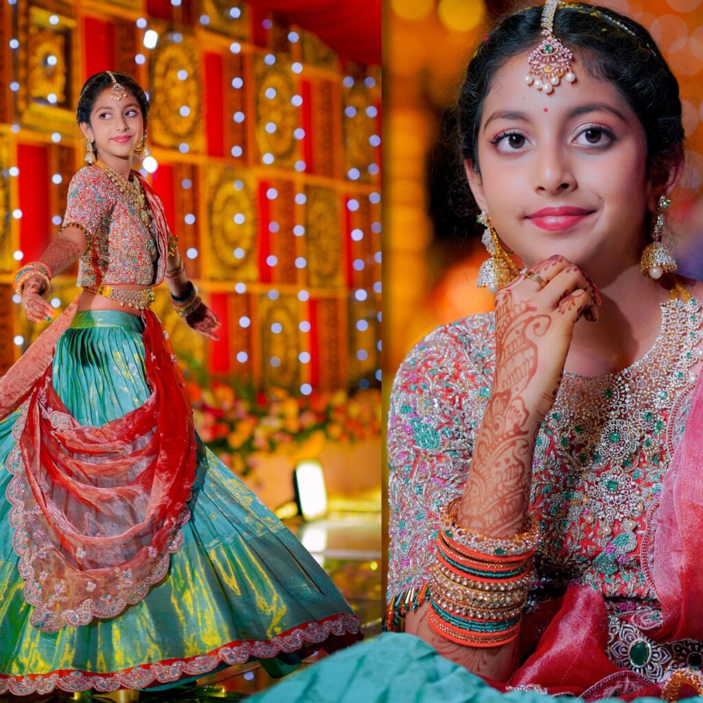 Ranhitha and Sanhitha elegantly dressed in half-sarees during the main ceremony, surrounded by family blessings.