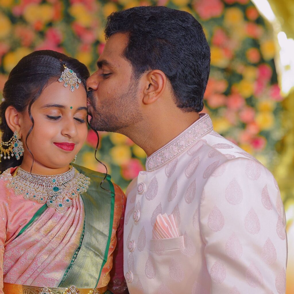Manasvini smiling in her Half Saree attire during the ceremony