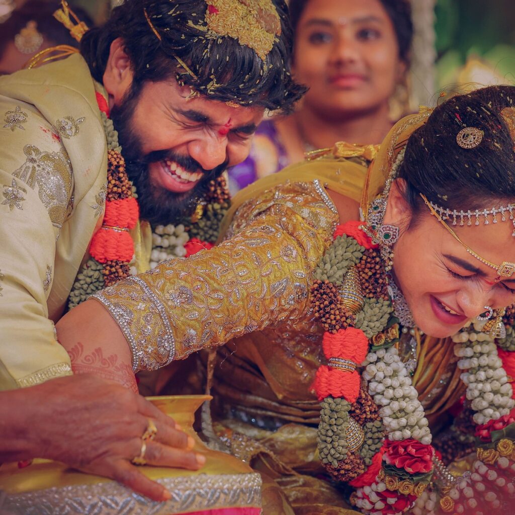 Nishitha and Akhil during their wedding rituals surrounded by family and traditions, photographed by PixelMatrix Photography.